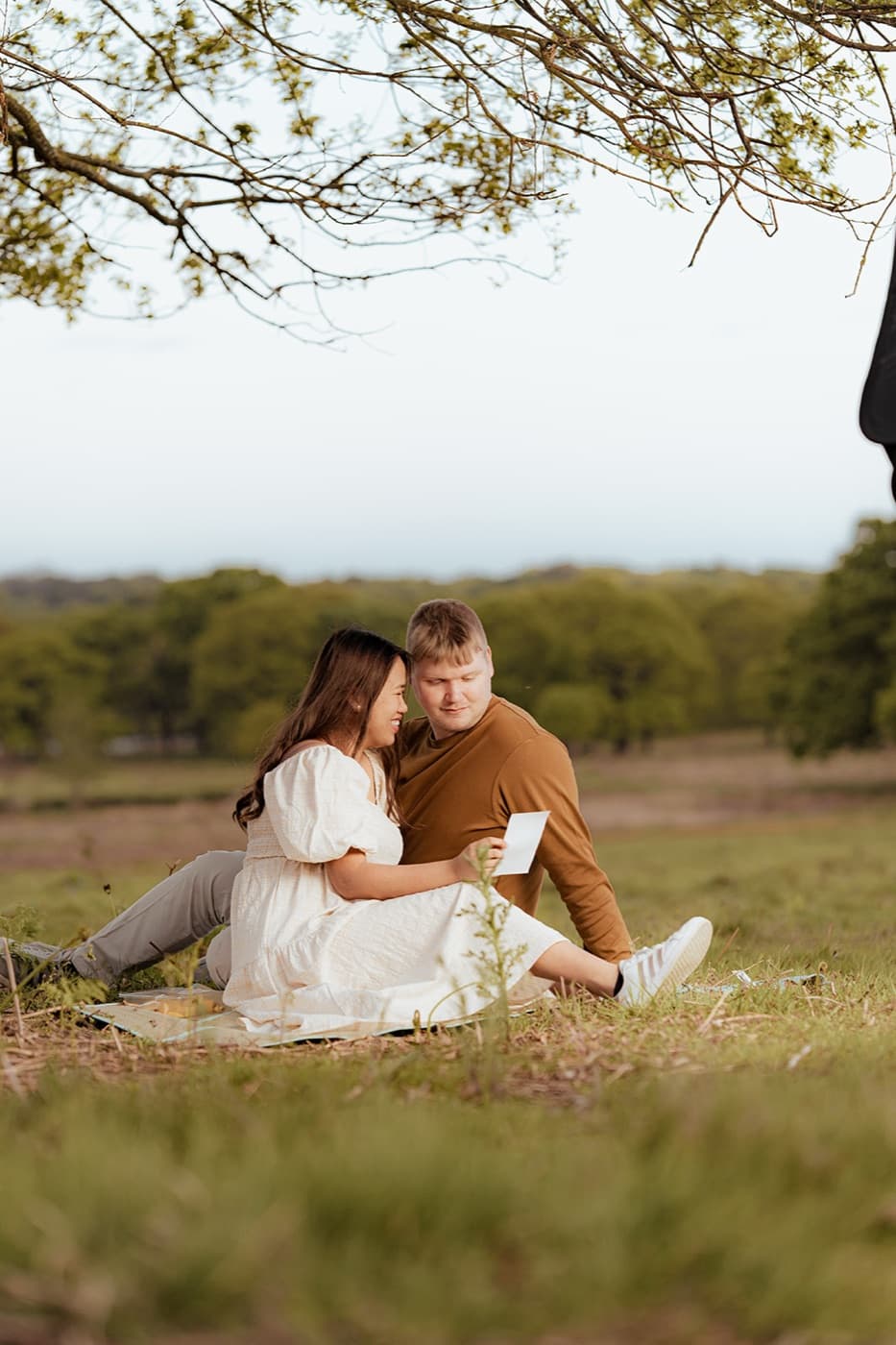 Couple at a picnic with baby scan, portrait photography London