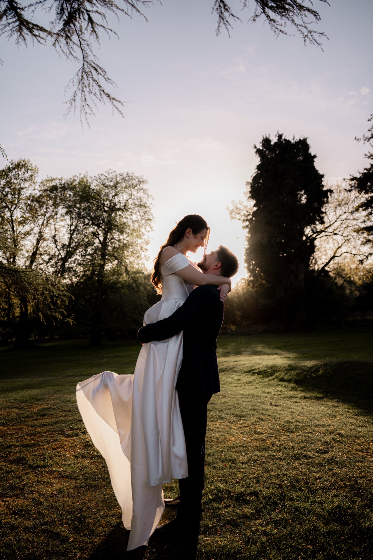 Bride and groom embracing at golden hour — documentary wedding photography by Evocation Photography